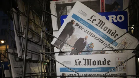 Stack with French Le Monde newspaper headline with Joe Biden and First lady Stock Footage 146997029