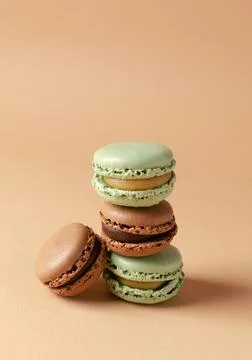 A stack of french macarons or macaroons, almond cookies on the beige backdr.. Stock Photos