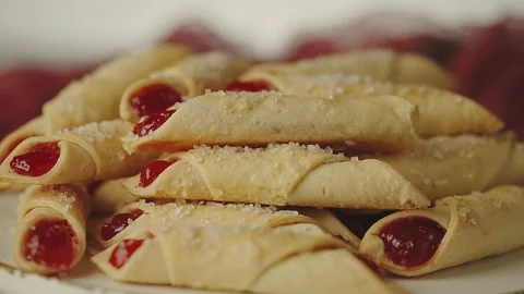 Stack of fresh and delicious cookies stuffed with red jam and sprinkled with Stock Footage 149737663