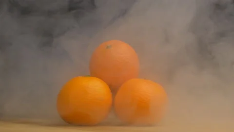 A stack of fresh and juicy tangerines that rotate on a black background and from Video stock 103194469