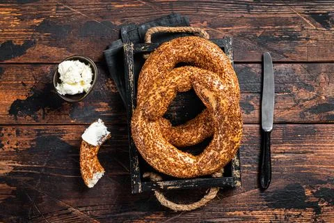 Stack of fresh baked Turkish simit bagel with kaymak. Wooden background. Top Stock Photos