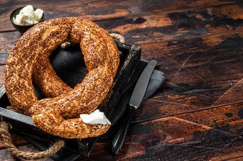 Stack of fresh baked Turkish simit bagel with kaymak. Wooden background. To.. Stock Photos