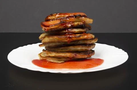 A stack of fresh, delicious pancakes with red berry syrup. Breakfast, dessert Stock Photos