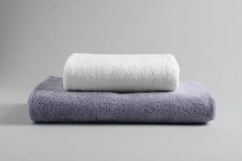 Stack of fresh fluffy towels on grey background 库存照片