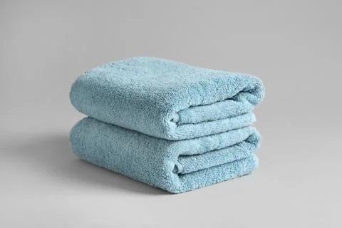 Stack of fresh fluffy towels on grey background 스톡 사진