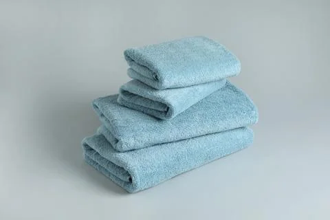 Stack of fresh fluffy towels on grey background 스톡 사진