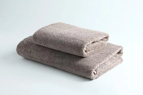 Stack of fresh fluffy towels on grey background 写真素材