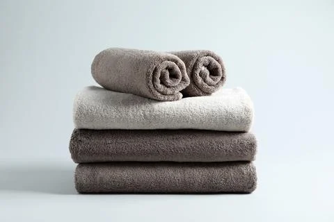 Stack of fresh fluffy towels on grey background 스톡 사진