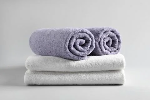 Stack of fresh fluffy towels on grey background 写真素材