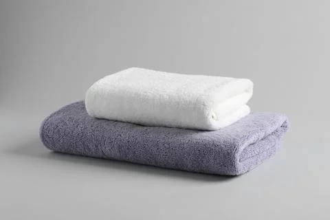 Stack of fresh fluffy towels on grey background 스톡 사진
