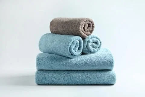 Stack of fresh fluffy towels on grey background 스톡 사진