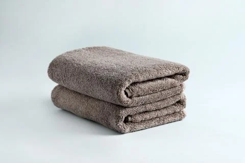 Stack of fresh fluffy towels on grey background 写真素材