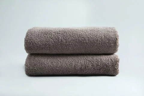 Stack of fresh fluffy towels on grey background Stock Photos