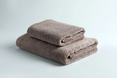 Stack of fresh fluffy towels on grey background 스톡 사진