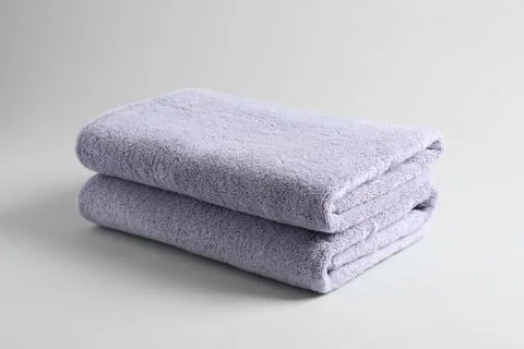 Stack of fresh fluffy towels on grey background 库存照片