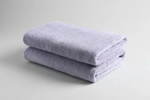 Stack of fresh fluffy towels on grey background 스톡 사진