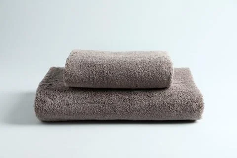 Stack of fresh fluffy towels on grey background 스톡 사진