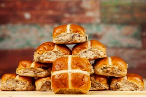 Stack of fresh golden hot cross buns Stock Photos