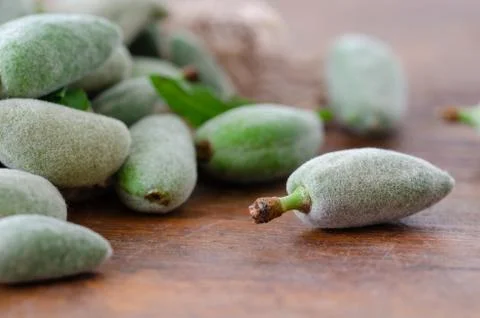 Stack of Fresh Green Almond Nut Fruits On Table Stock Photos
