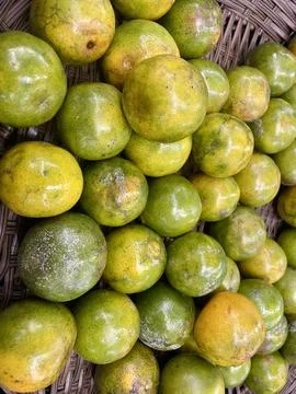 Stack of Fresh Green and Yellow Tropical Citrus Fruits Stock Photos