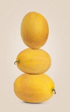 Stack of fresh melons on beige background Stock Photos