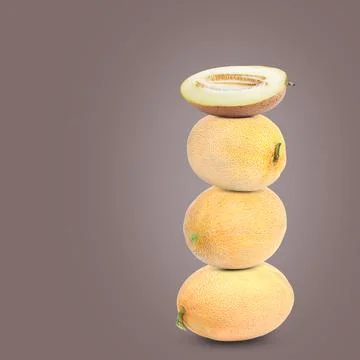Stack of fresh melons on pale brown background. Space for text Foto stock