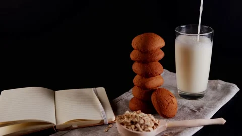 Stack of fresh oatmeal cookies with raw oat flakes in large wooden spoon, open Stock Footage 204954945