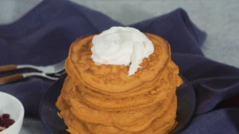 Stack of fresh pumpkin pancakes on a black plate. Stock Footage 153307982