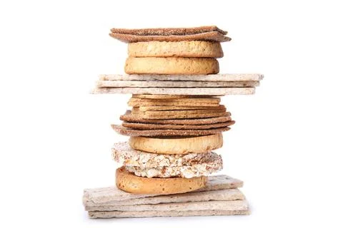 Stack of fresh rye crispbreads, crunchy rice cakes and rusks on white backg.. 库存照片
