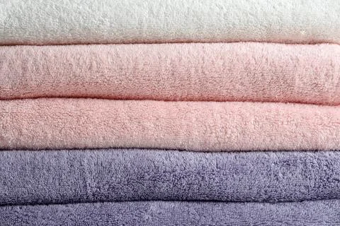 Stack of fresh soft towels as background Stockfoto's