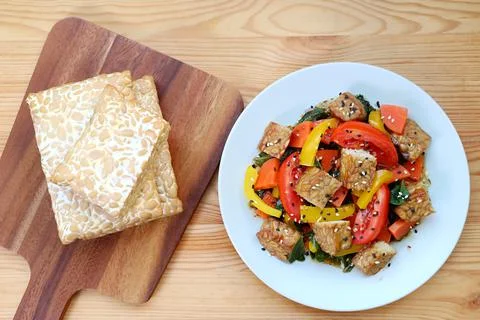 Stack of fresh Tempeh and colorful vegetables salad with roasted Tempeh cubes Stockfoto's