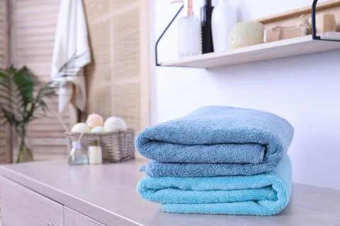 Stack of fresh towels on cabinet in bathroom. Space for text 스톡 사진