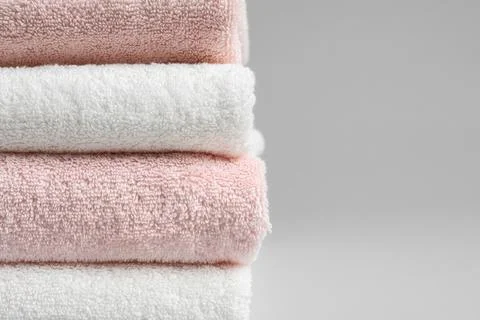 Stack of fresh towels on grey background, closeup. Space for text 스톡 사진