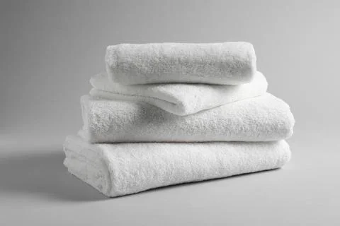 Stack of fresh towels on light background 写真素材