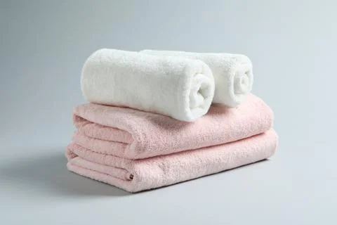 Stack of fresh towels on light background Stockfoto's