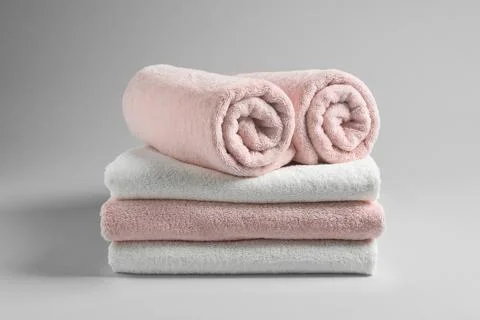Stack of fresh towels on light background 写真素材