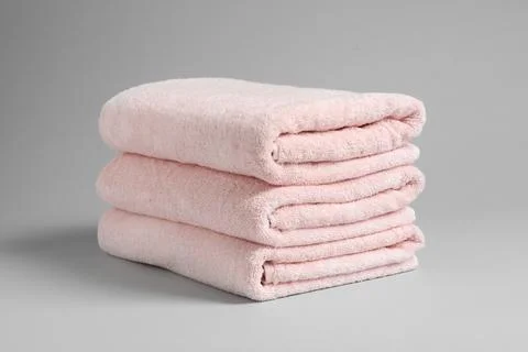 Stack of fresh towels on light background 스톡 사진