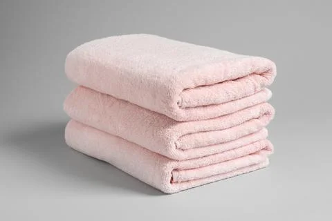 Stack of fresh towels on light background 스톡 사진
