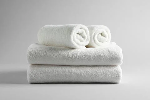 Stack of fresh towels on light background 库存照片