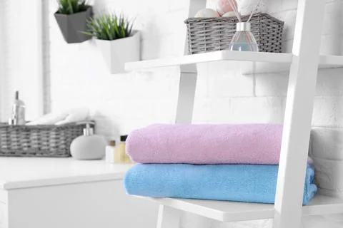Stack of fresh towels on shelf in bathroom. Space for text 스톡 사진