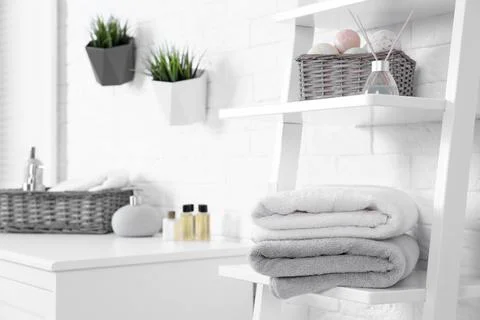 Stack of fresh towels on shelf in bathroom. Space for text 写真素材