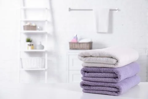 Stack of fresh towels on table in bathroom. Space for text 스톡 사진