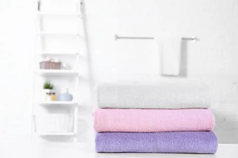 Stack of fresh towels on table in bathroom. Space for text 스톡 사진