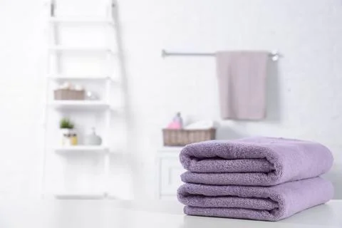 Stack of fresh towels on table in bathroom. Space for text Foto stock