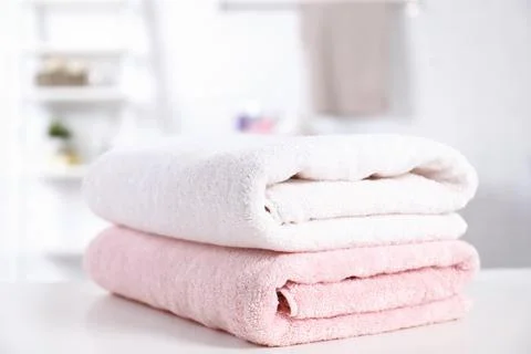 Stack of fresh towels on table in bathroom Stockfoto's