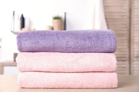 Stack of fresh towels on table in bathroom 스톡 사진