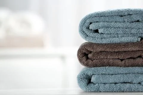 Stack of fresh towels on table, closeup. Space for text 스톡 사진