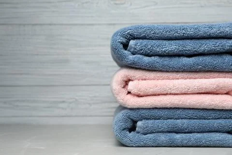 Stack of fresh towels on table. Space for text 스톡 사진