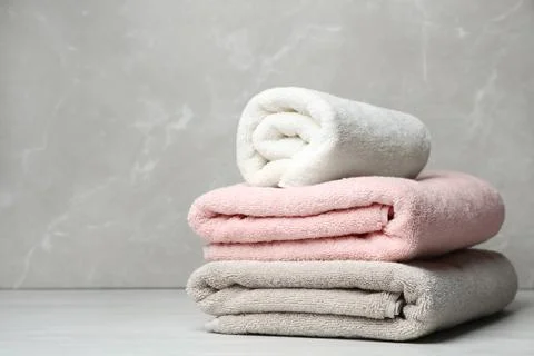 Stack of fresh towels on table. Space for text 스톡 사진