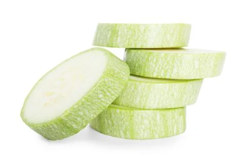 Stack of fresh zucchini pieces isolated on white Foto stock